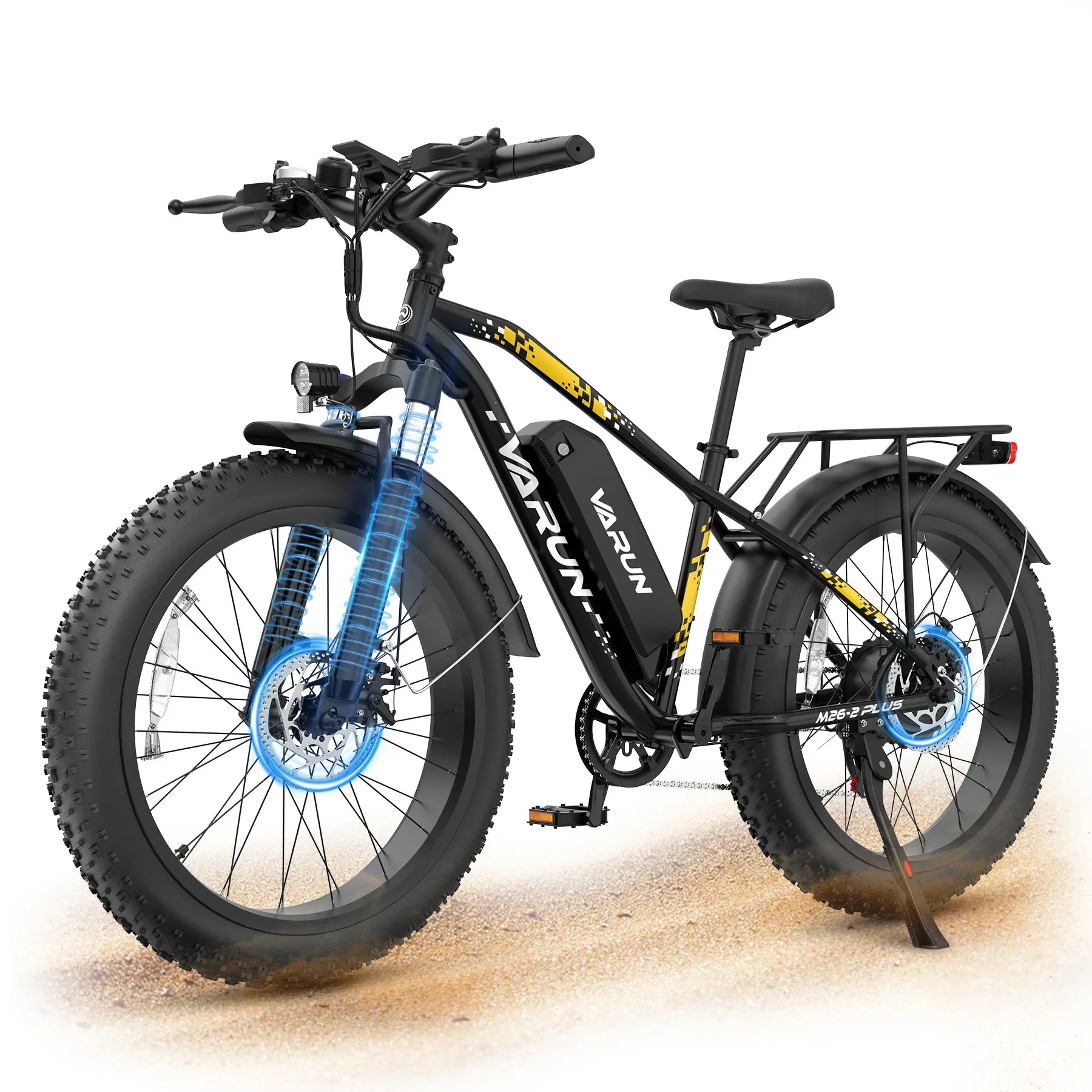 Black and yellow Varun electric fat tire bike with front suspension, rear rack, and disc brakes on sandy ground