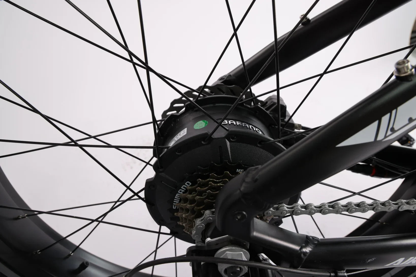 Close-up of black Bafang electric bike rear wheel hub motor with Shimano gears and chain