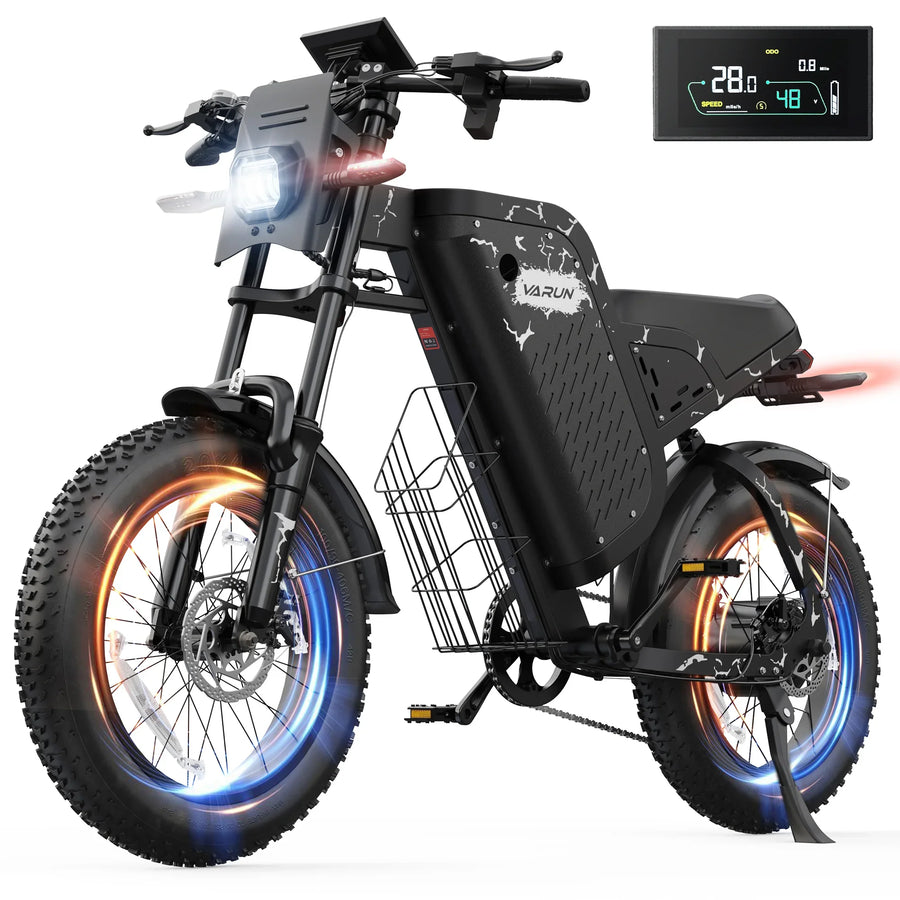 Black Varun electric bike with fat tires, front light on, digital speed display, and side basket