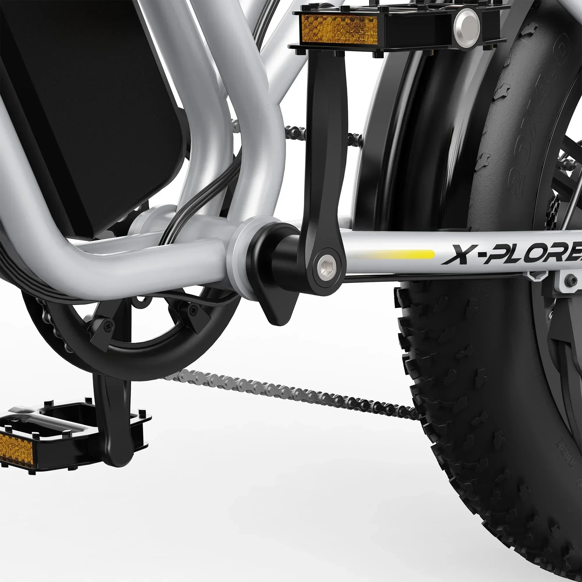 Close-up of silver X-Plorer electric mountain bike crankset, chain, and fat tire with pedal and frame details