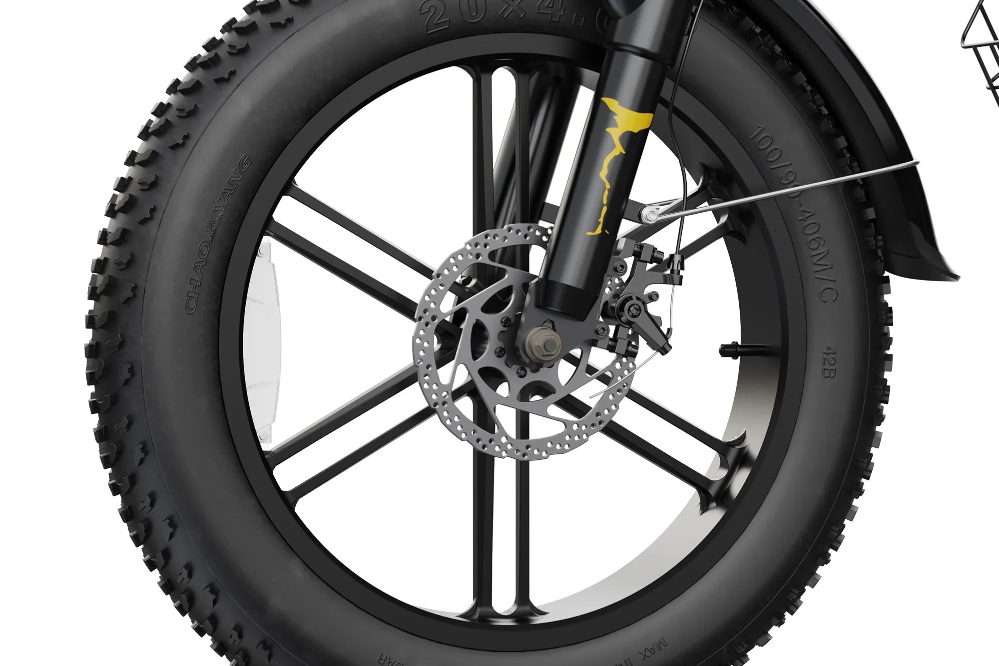 Close-up of electric bike front wheel with disc brake, thick knobby tire, and yellow graphic on fork