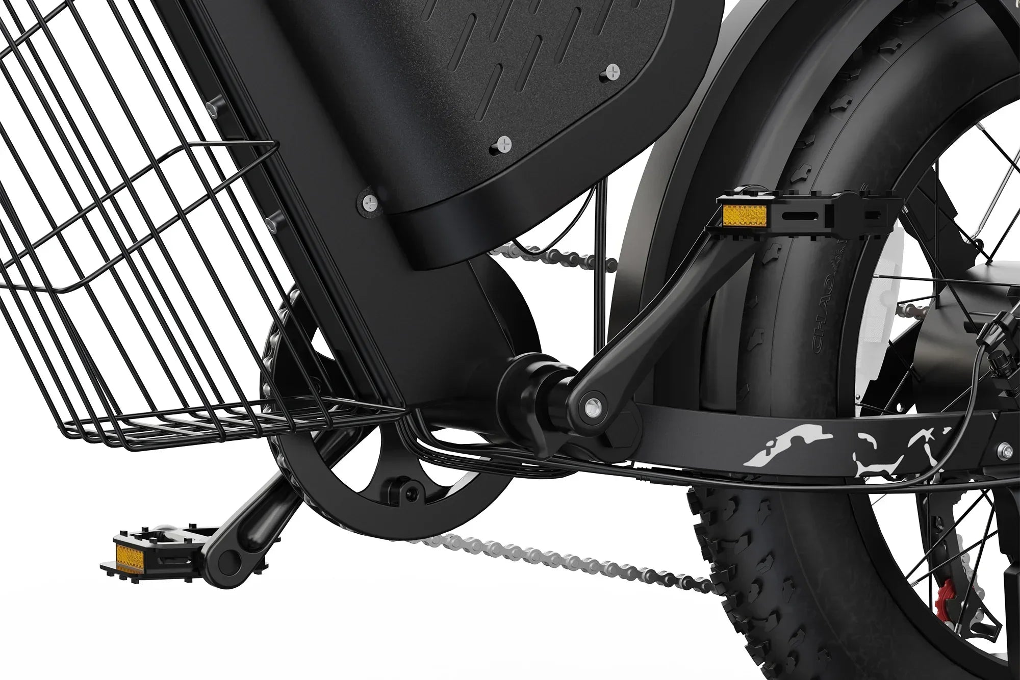 Close-up of black electric bike pedal, chain, rear tire, and metal rear basket