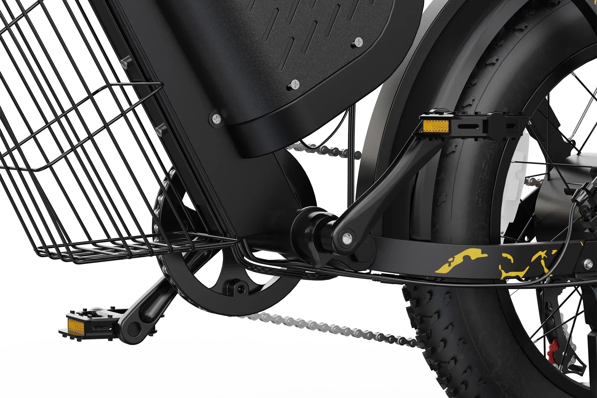 Close-up of black electric bicycle pedal, chain, rear wheel with thick tire, and metal basket